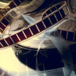 An old film with a movie on the roll. Background for advertising old cinema